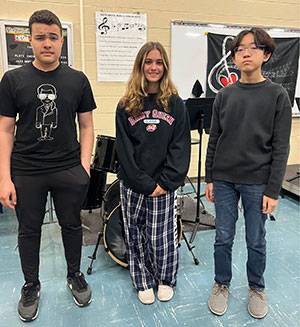 Band students standing in front of instruments