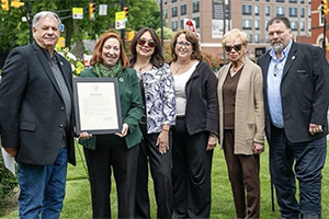 Dr. Spollen-LaRaia accepting a plaque