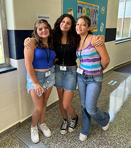 Three happy girls in the school hallway